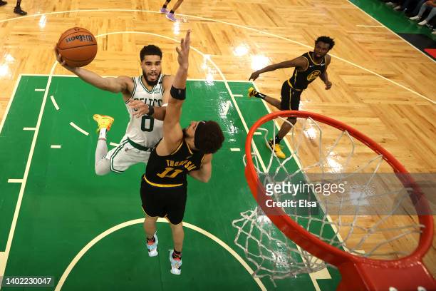 Jayson Tatum of the Boston Celtics drives to the basket against Klay Thompson of the Golden State Warriors in the second half during Game Four of the...