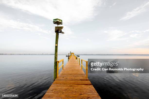 pier over sea against dramatic sky - orange county stockfoto's en -beelden