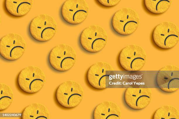 sad emoji face seamless pattern in yellow background - rage photos et images de collection