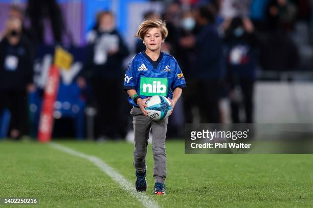 Child delivers the match match ball to the field during the Super Rugby Pacific Semi Final match between the Blues and the Brumbies at Eden Park on...