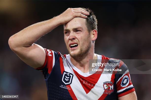 Luke Keary of the Roosters holds his head as he leaves the field for an HIA during the round 14 NRL match between the Sydney Roosters and the...