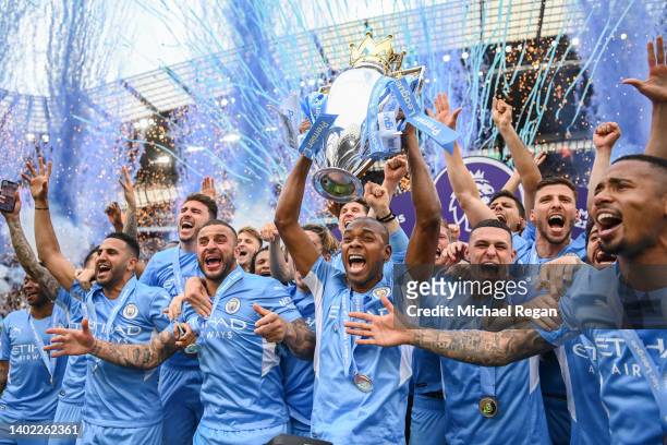 Fernandinho of Manchester City lifts the Premier League trophy with team mates Riyad Mahrez, Kyle Walker, Phil Foden, Kevin De Bruyne, Ruben Diaz and...