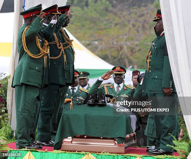 Soldiers salute Nigeria's secessionist leader Odumegwu Ojukwu during the national inter-denominational funeral rites at Michael Opkara Square in...