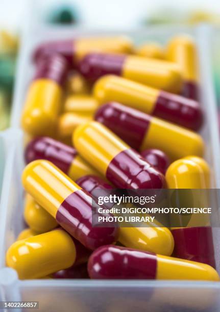 red and yellow capsules - alternative therapy stock illustrations