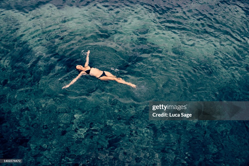 Female Enjoying A Relaxing Sea Swim In Ibiza