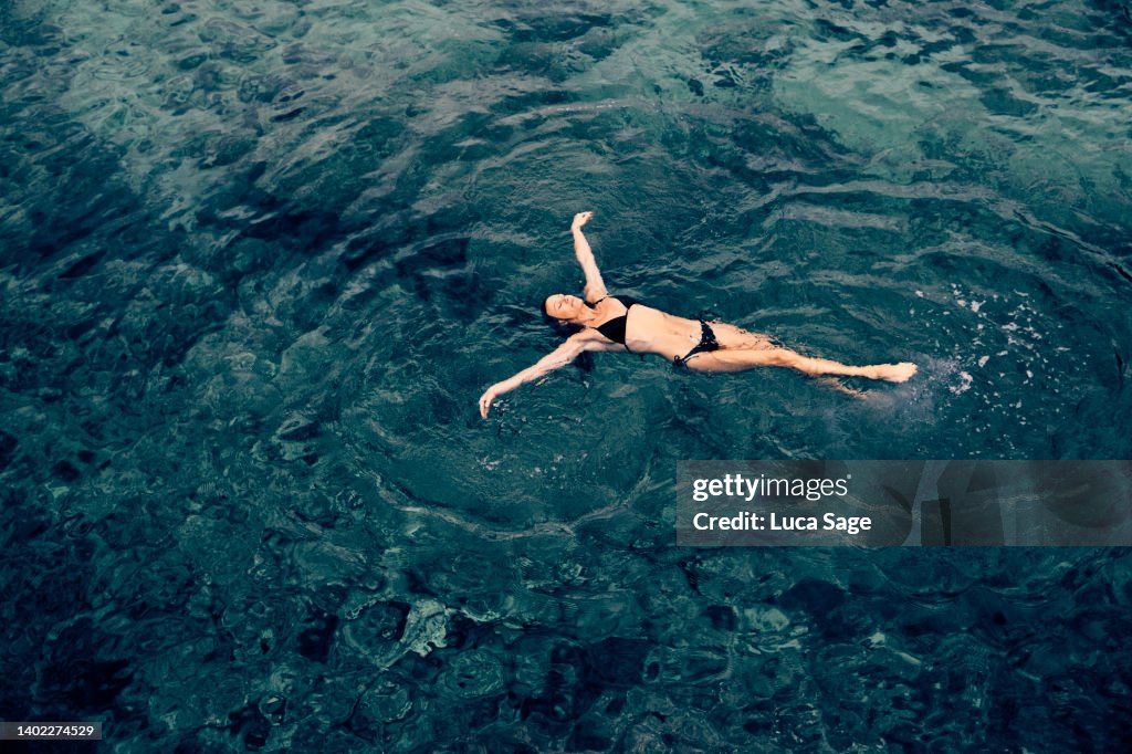Female Enjoying A Relaxing Sea Swim In Ibiza