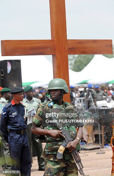 Soldier guarding the funeral of Nigeria secessionist leader Odumegwu Ojukwu stands before a cross during the national inter-denominational funeral...