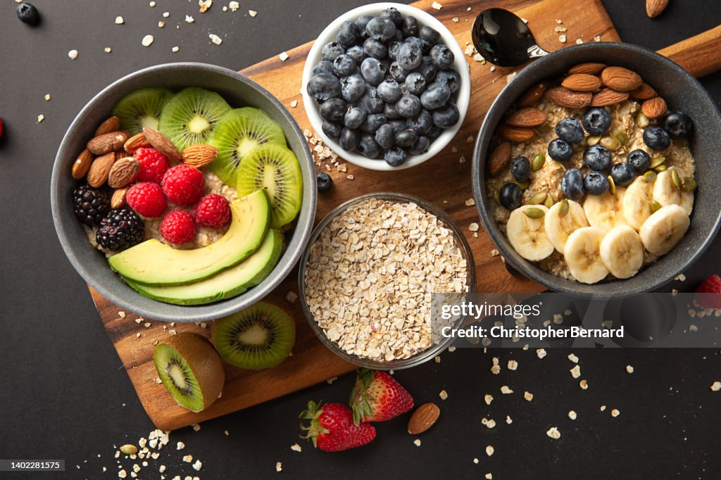 Bowls of oatmeal with mixed fruits topping