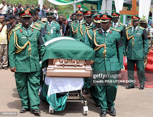 High ranking military officers and pall bearers carry the coffin of Nigeria's secessionist leader Odumegwu Ojukwu during the national...