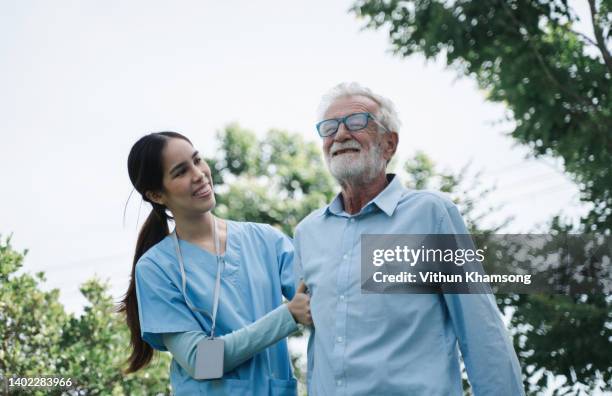 home healthcare asian nurse give help senior male patient - volunteer aged care stock pictures, royalty-free photos & images