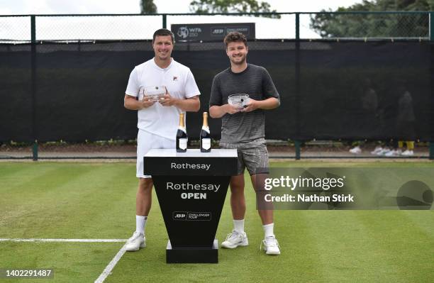 Ken Skupski and Jonny O'Mara of Great Britain pose with the Men's Doubles Trophy after beating Julian Cash and Henry Patten of Great Britain during...