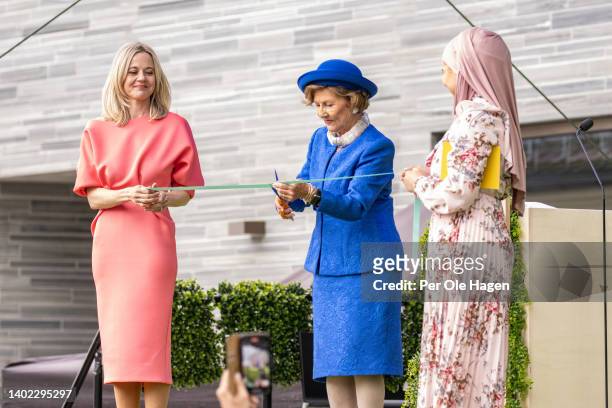 Managing Director Karin Hinsbo and the MC Iman Meskini watch as Queen Sonja of Norway cuts the ribbon at the opening of the Norwegian National Museum...