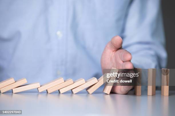 young businessman plays with donimoes - dominoes stock pictures, royalty-free photos & images