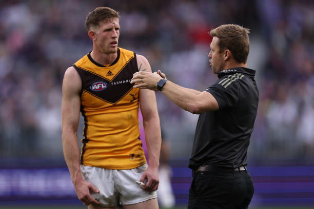 Sam Mitchell, head coach of the Hawks talks with Sam Frost during the round 13 AFL match between the Fremantle Dockers and the Hawthorn Hawks at...