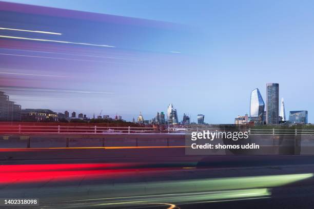 cityscape of london skyline at dusk with light trail - central london traffic stock pictures, royalty-free photos & images