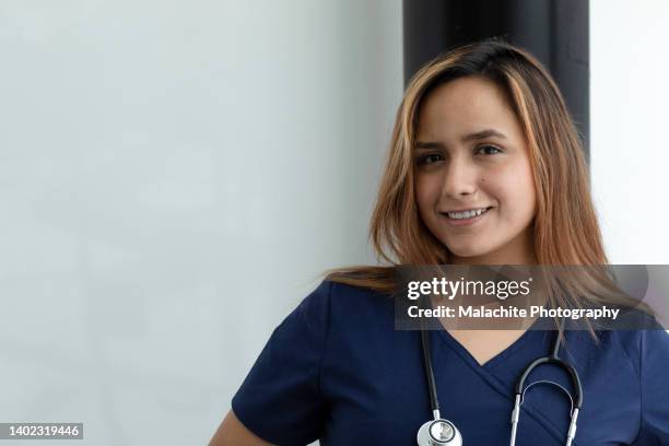 confident colombian nurse in medical building - mental health awareness month stock pictures, royalty-free photos & images