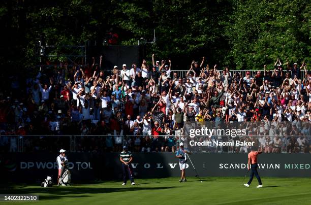 Henrik Stenson of Sweden celebrates with the stands packed full of fans after a birdie putt on the 16th green during Day Three of the Volvo Car...