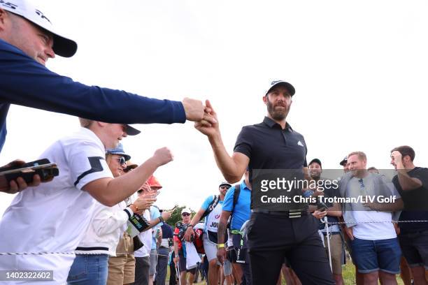 Dustin Johnson of The United States bumps fists during day three of LIV Golf Invitational - London at The Centurion Club on June 11, 2022 in St...