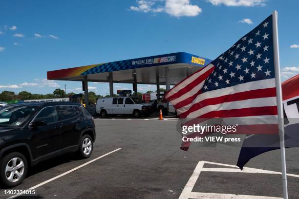 Flag is placed at a gas station on June 11, 2022 in Woodbridge, New Jersey. The costs of petrol, food and other necessities jumped in May, rising...