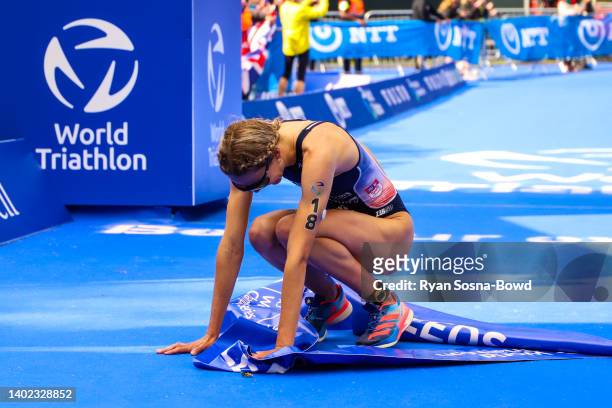 France's Cassandre Beaugrand collapse with joy after taking victory in the women's race at the AJ Bell Leeds World Triathlon Championship Series race...