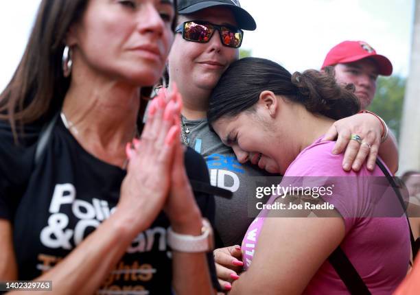 Melissa Pages Sherman hugs her daughter, Rebecca Sherman, as they listen to people speak during the second March for Our Lives rally against gun...