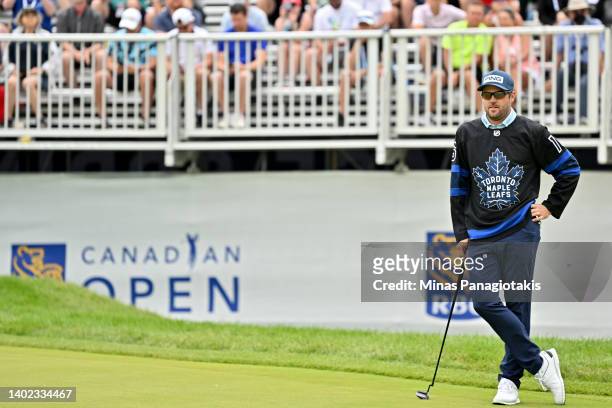 Corey Conners of Canada looks on from the 16th green while wearing the uniform of Mitchell Marner of the Toronto Maple Leafs during the third round...