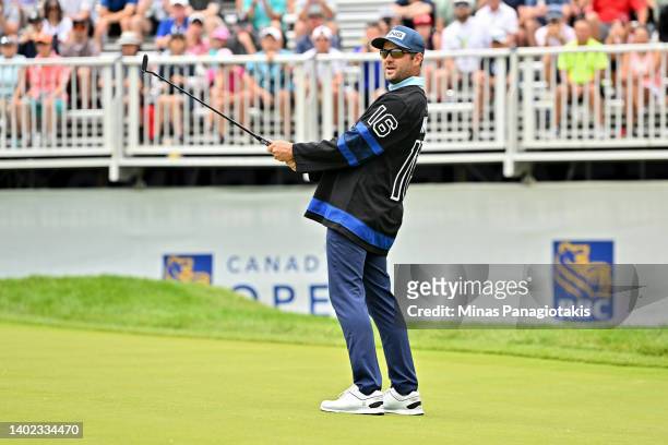 Corey Conners of Canada reacts after missing a putt on the 16th green while wearing the uniform of Mitchell Marner of the Toronto Maple Leafs during...
