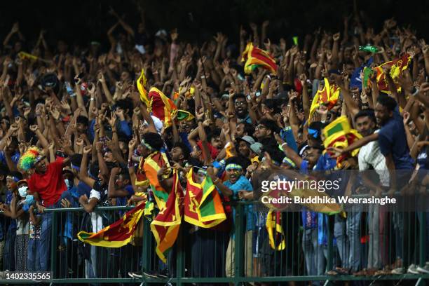 Sri Lankan cricket fans cheer during the 3rd match in the T20 International series between Sri Lanka and Australia at Pallekele Cricket Stadium on...