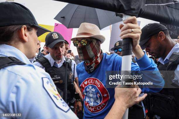 Counter-protester is detained by U.S. Park Police as they attempt to disrupt a March for Our Lives rally against gun violence on the National Mall...