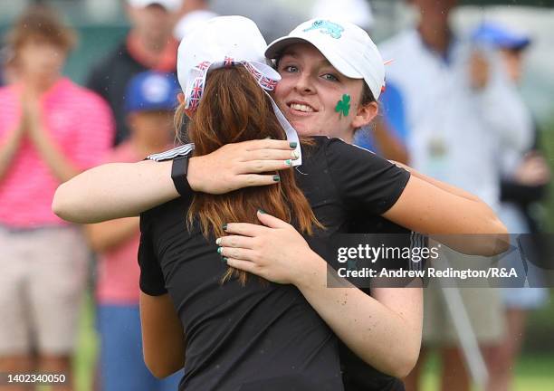 Lauren Walsh and Caley McGinty of Team Great Britain and Ireland embrace after their victory on the 14th green during the Morning Fourballs on Day...