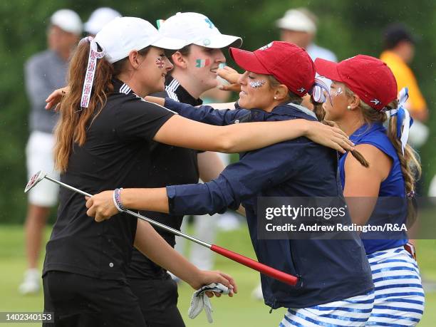 Lauren Walsh and Caley McGinty of Team Great Britain and Ireland embrace their opponents Rachel Kuehn and Jensen Castle of Team USA after their...