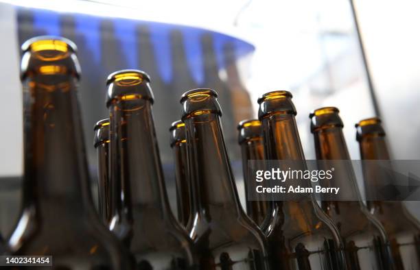 Empty beer bottles sit on the conveyor belt of an unoperated bottling machine as brewer Vagabund Brauerei waits for more bottles to be delivered...