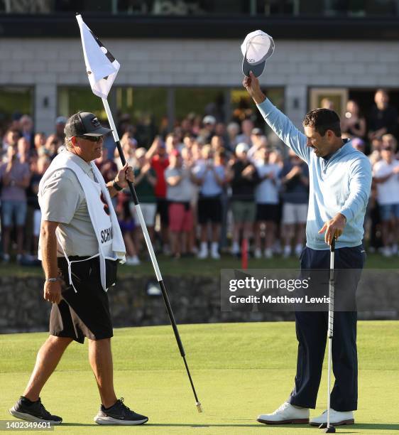 Charl Schwartzel of South Africa celebrates with his caddie after winning the LIV Golf Invitational at The Centurion Club on June 11, 2022 in St...