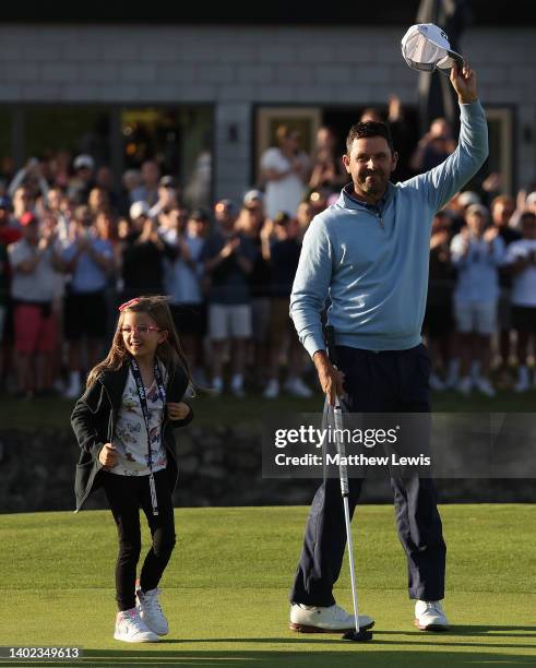 Charl Schwartzel of South Africa celebrates with his daughter after winning the LIV Golf Invitational at The Centurion Club on June 11, 2022 in St...