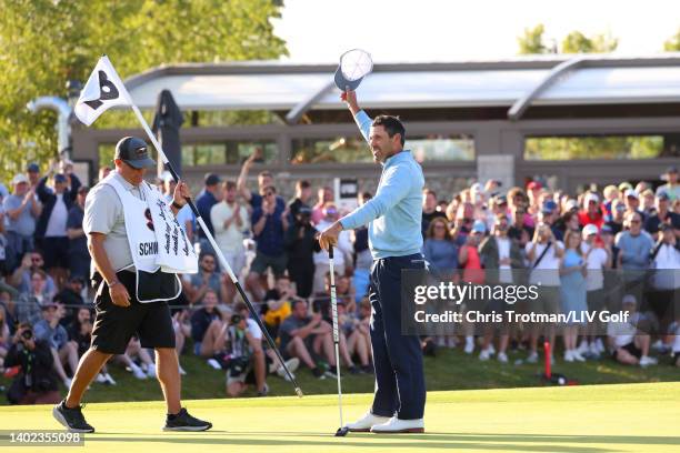 Charl Schwartzel of Stinger GC celebrates with his caddie Heath Holt on the 18th green following victory during day three of LIV Golf Invitational -...