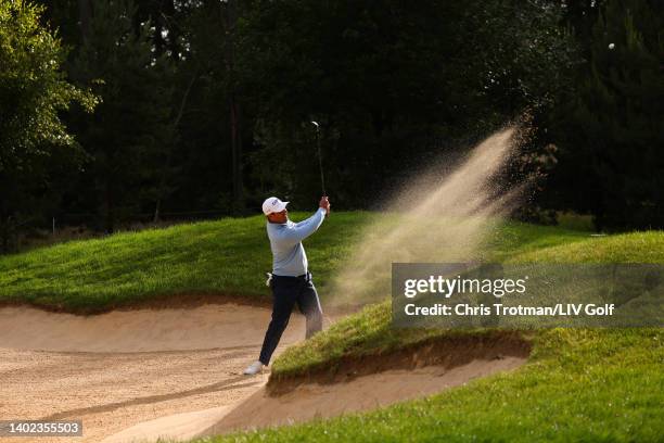 Charl Schwartzel of Stinger GC plays a shot from a bunker on the 14th hole during day three of LIV Golf Invitational - London at The Centurion Club...