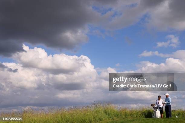 Charl Schwartzel of Stinger GC and caddie Heath Holt wait on the 13th tee during day three of LIV Golf Invitational - London at The Centurion Club on...