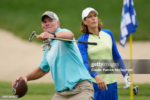 Former NFL player Brett Favre throws a football to a fan on the 14th green during the Celebrity Foursome at the second round of the American Family...