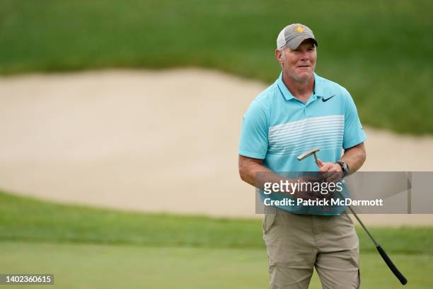 Former NFL player Brett Favre stands on the 14th green during the Celebrity Foursome at the second round of the American Family Insurance...