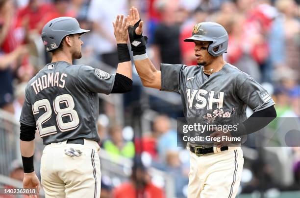 Lane Thomas and Cesar Hernandez of the Washington Nationals celebrate after scoring in the third inning against the Milwaukee Brewers at Nationals...