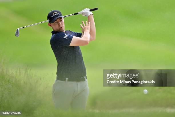 Matt Fitzpatrick of England plays his shot from the bunker on the ninth hole during the third round of the RBC Canadian Open at St. George's Golf and...
