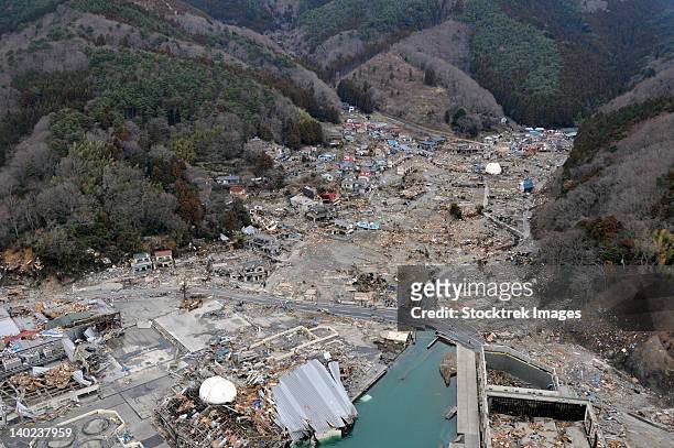 a helicopter team surveys the tsunami and earthquake damage over japan. - emergencies and disasters imagens e fotografias de stock