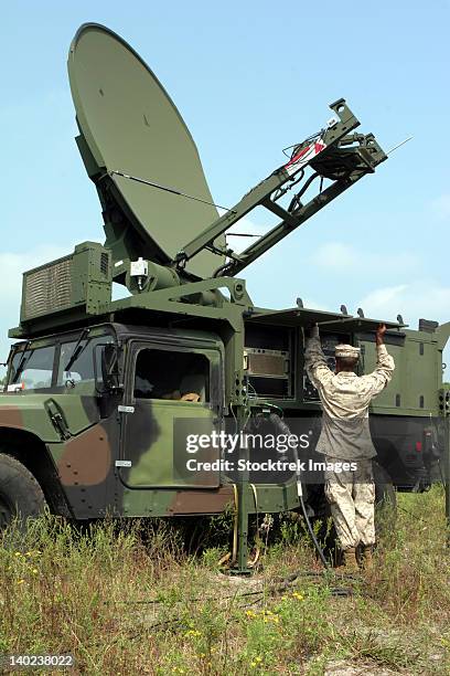 a satellite communications chief checks the phoenix communications system during a field-training exercise. - military communications stock pictures, royalty-free photos & images