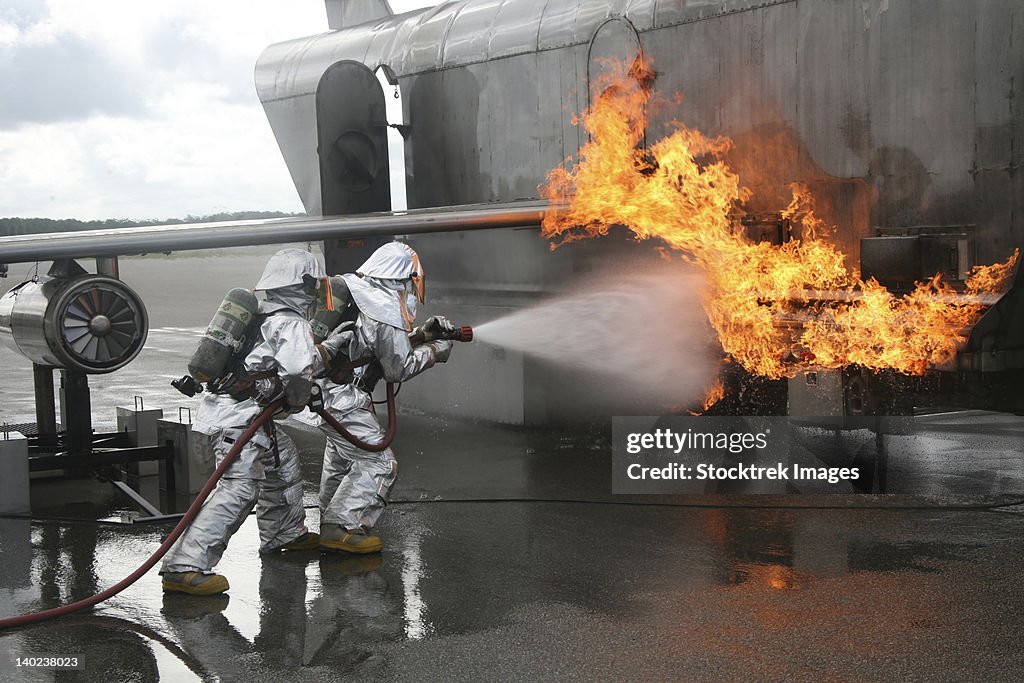 Firefighters extinguish an exterior fire during a training exercise.