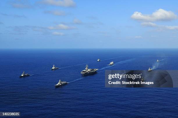 ships from the ronald reagan carrier strike group transit the pacific ocean. - convoy stock pictures, royalty-free photos & images