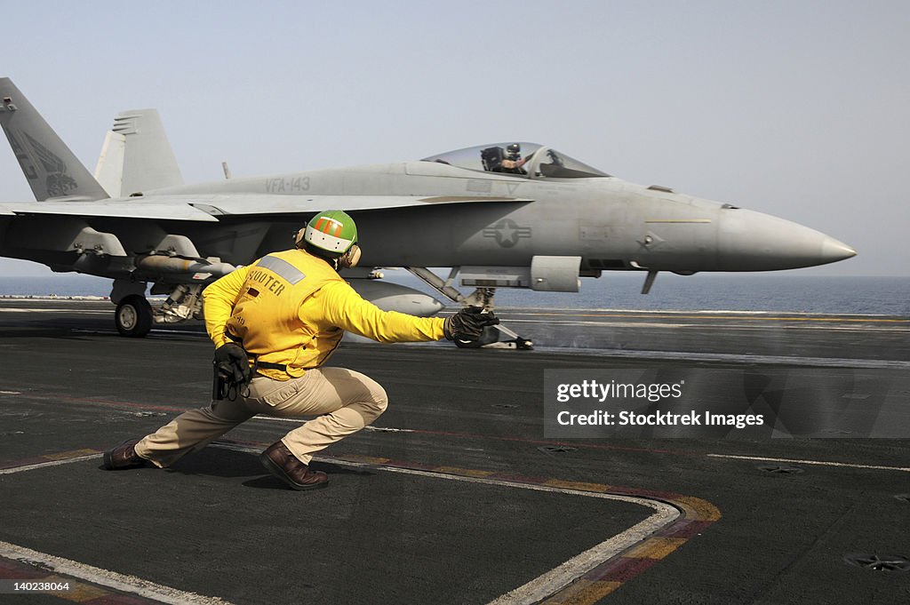 A shooter launches an F/A-18E Super Hornet from USS Dwight D Eisenhower.