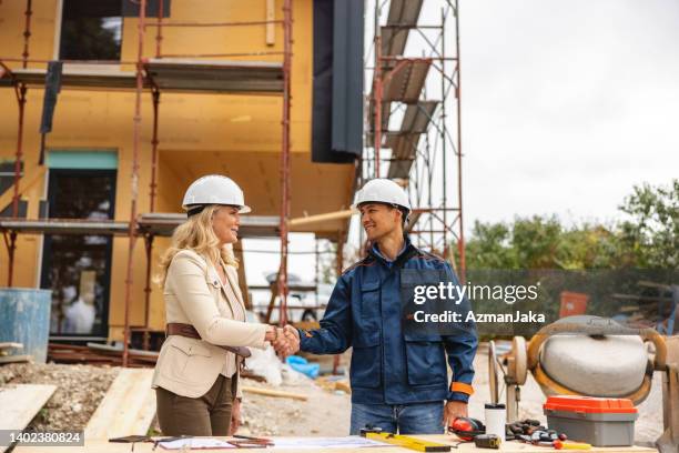 female architect and civil engineer hadshake at construction site - handshake site stock pictures, royalty-free photos & images