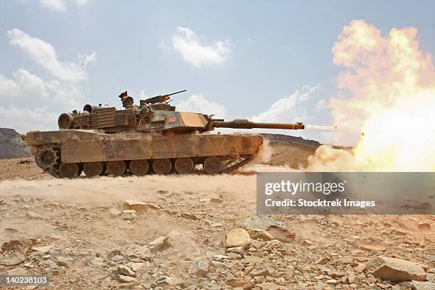 marines bombard through a live fire range using m1a1 abrams tanks. - m1 abrams stock pictures, royalty-free photos & images