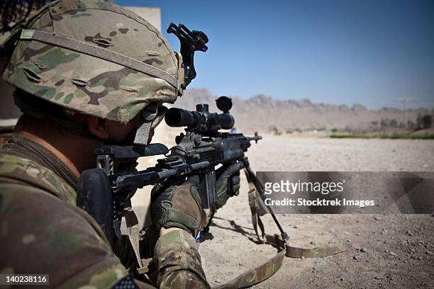 u.s. army sniper pulls security using an mk14 enhanced battle rifle. - afghanistan people stock pictures, royalty-free photos & images