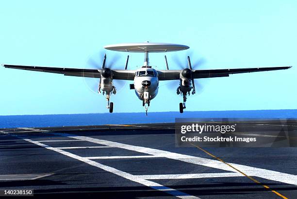 an e-2c hawkeye approaches for landing aboard uss john c stennis. - landing on aircraft carrier stock pictures, royalty-free photos & images